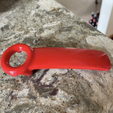 A red JarKey laying on a counter